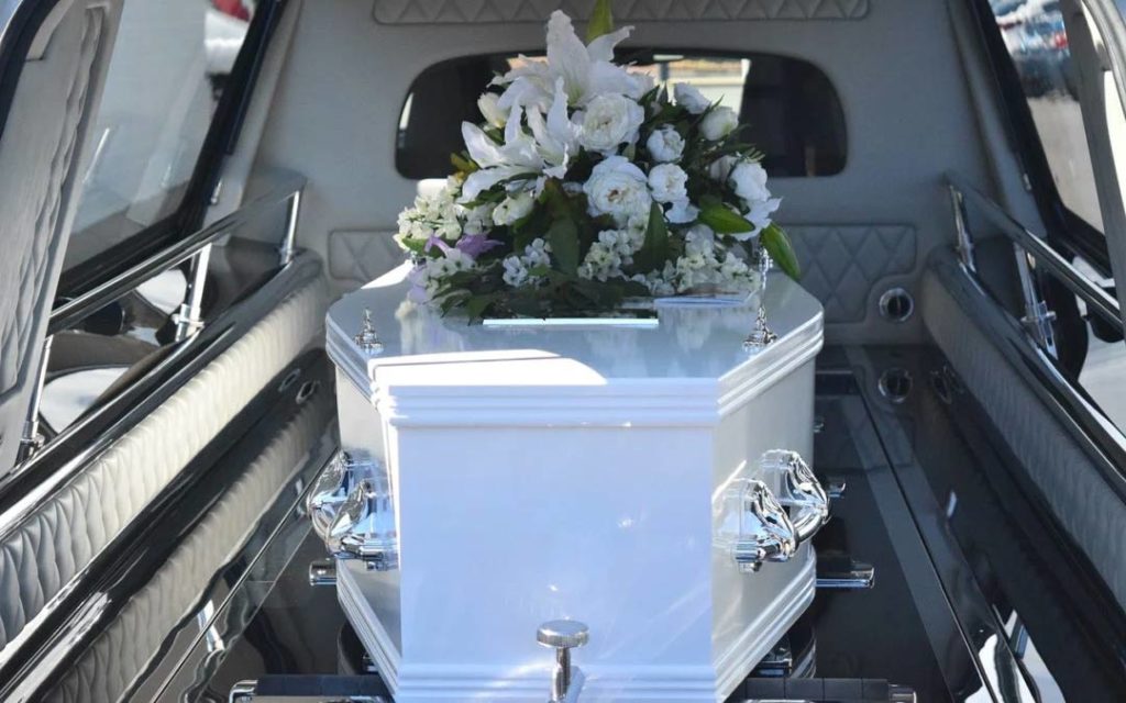 flowers on a casket in hearse