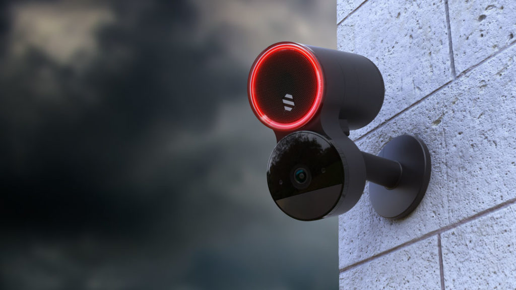 image of deep sentinel camera front view with red led in a grey background